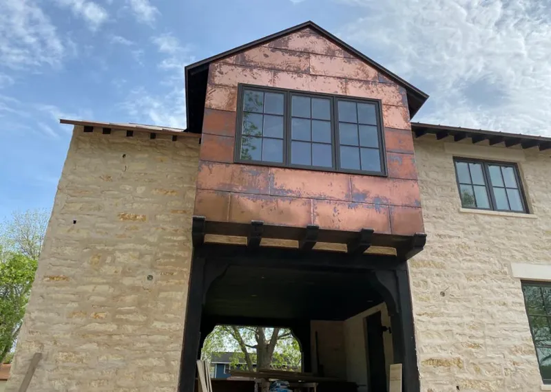 Copper metal panel facade on a stone building for Metal Roof Coating in Brownsville