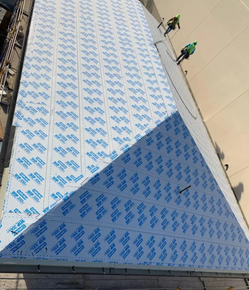 Professional roofers installing underlayment on a metal roof in Brownsville